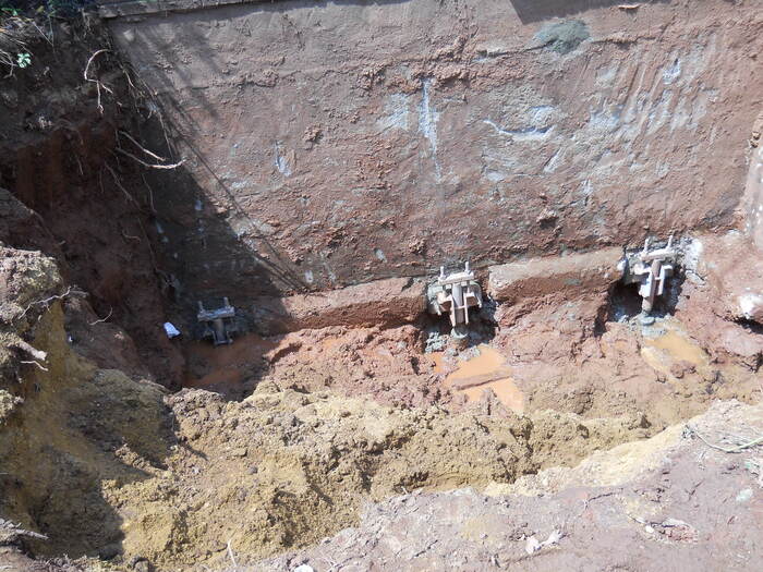 Helical piers installed in a deep excavation site