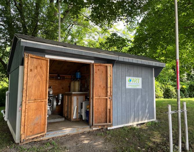Groundwater treatment shed with open doors and equipment